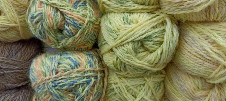 Multi-colored skeins of thread folded in a stack close-up Stock Photos