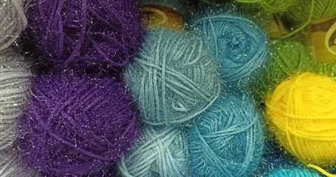 Multi-colored skeins of thread folded in a stack close-up Stock Photos