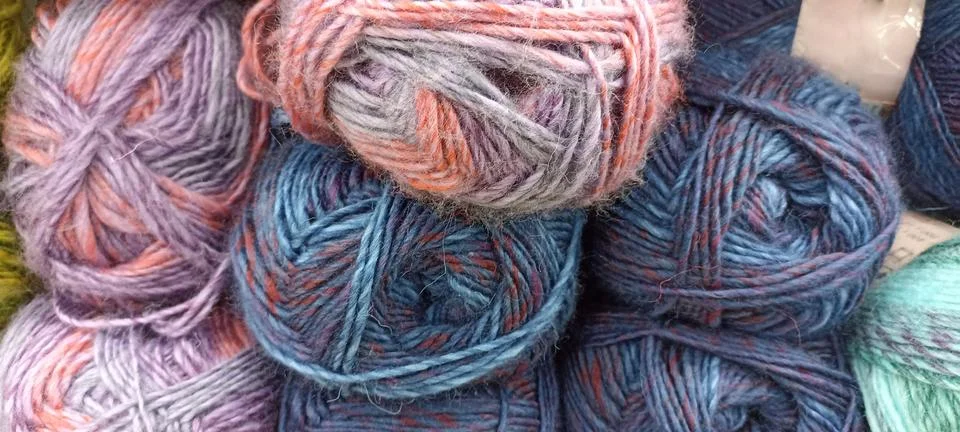 Multi-colored skeins of thread folded in a stack close-up Stock Photos