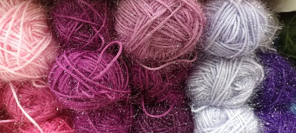 Multi-colored skeins of thread folded in a stack close-up Stock Photos