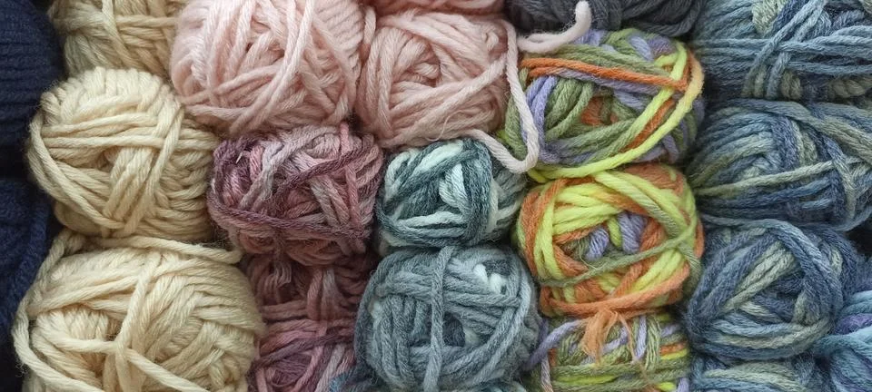 Multi-colored skeins of thread folded in a stack close-up Stock Photos