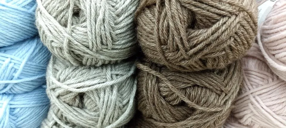 Multi-colored skeins of thread folded in a stack close-up Stock Photos
