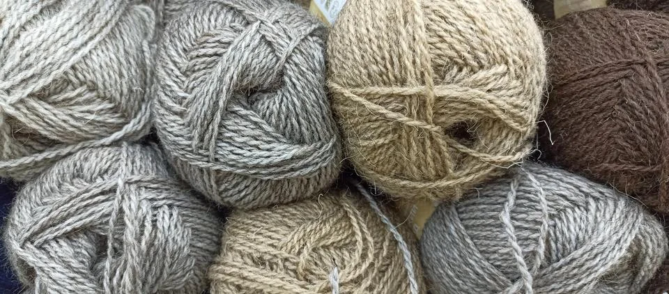 Multi-colored skeins of thread folded in a stack close-up Stock Photos