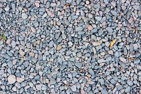 Multi-colored small crushed stone lies on the ground Stock Photos