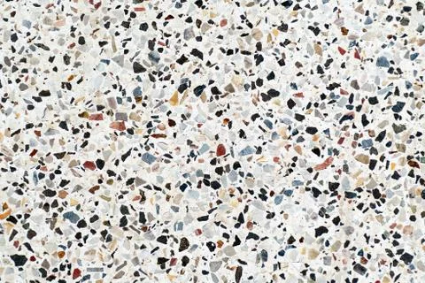 Multi-colored small flat stones on a gray background. Stock Photos
