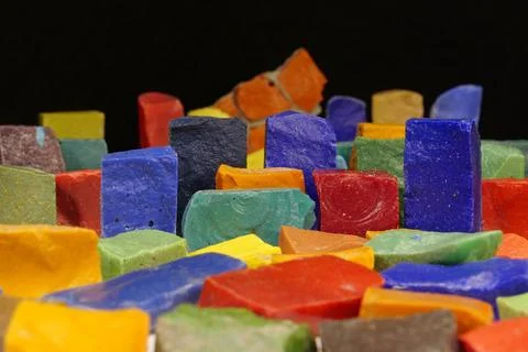 Multi-colored smalt from old Soviet mosaics on black background 库存照片