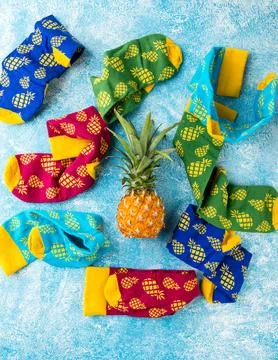 Multi-colored socks with pattern of pineapples Stock Photos