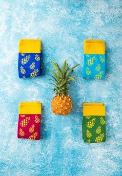 Multi-colored socks with pattern of pineapples Stock Photos