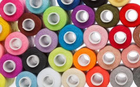 Multi-colored spools of sewing thread on a white background Stock Photos