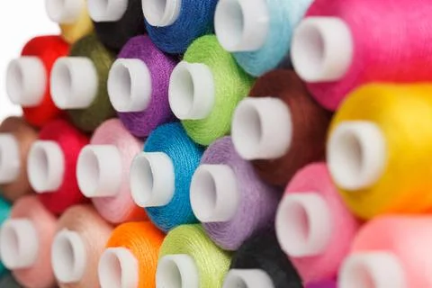 Multi-colored spools of sewing thread on a white background Stock Photos