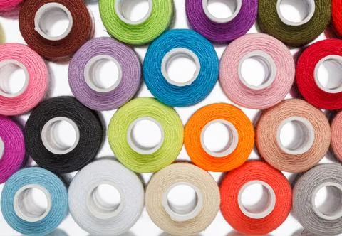 Multi-colored spools of sewing thread on a white background Stock Photos