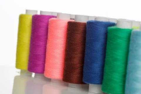 Multi-colored spools of sewing thread on a white background Stock Photos