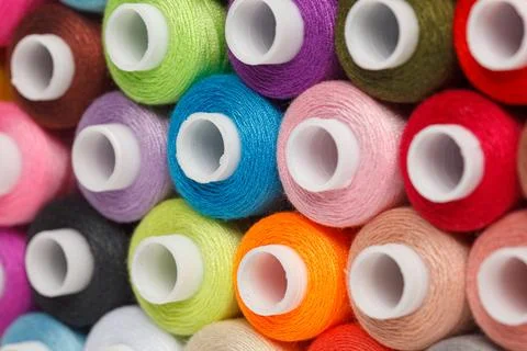 Multi-colored spools of sewing thread on a white background Stock Photos