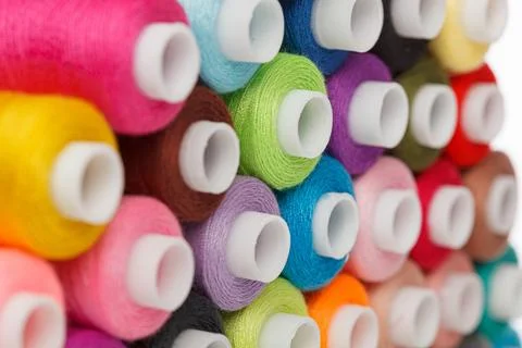 Multi-colored spools of sewing thread on a white background Foto stock