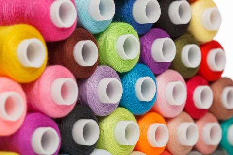 Multi-colored spools of sewing thread on a white background 写真素材