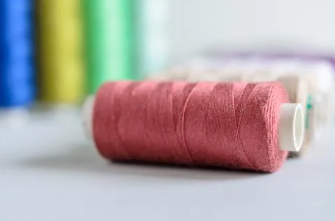 Multi-colored spools of sewing threads close-up. Craft and hobby concept. Stock Photos