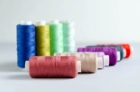 Multi-colored spools of sewing threads close-up. Craft and hobby concept. Stock Photos