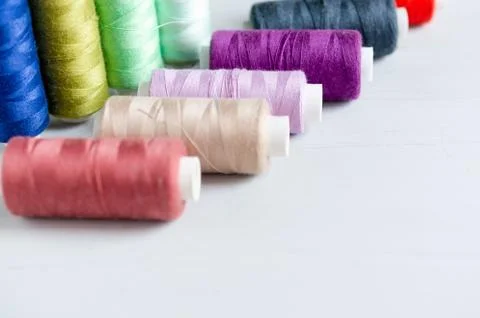 Multi-colored spools of sewing threads close-up. Craft and hobby concept. Stock Photos
