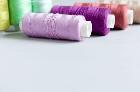 Multi-colored spools of sewing threads close-up. Craft and hobby concept. Stock Photos