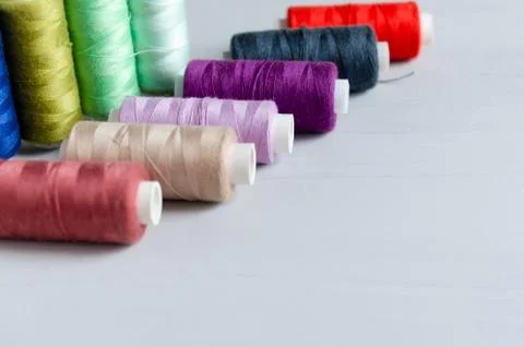 Multi-colored spools of sewing threads close-up. Craft and hobby concept. Stock Photos