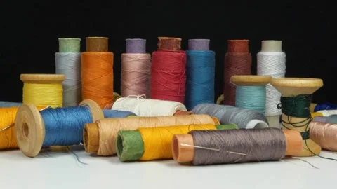 Multi-colored spools of thread on white table Stock-Footage 323330002