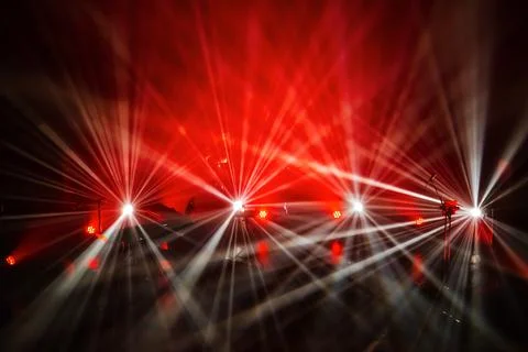 Multi-colored spotlights illuminate the stage before the concert. Stock Photos