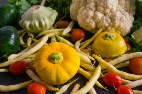 Multi-colored squash, cauliflower, cherry tomatoes and green beans Stock Photos