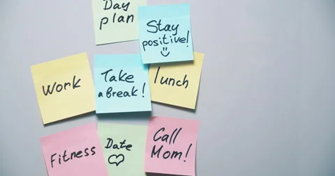 Multi-colored stickers with notes written with a marker and pasted on a board Stock Footage 130976635