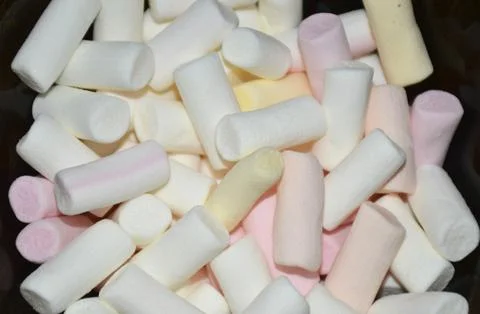 Multi-colored sticks of marshmallow marshmallows in a glass bowl Stock Photos