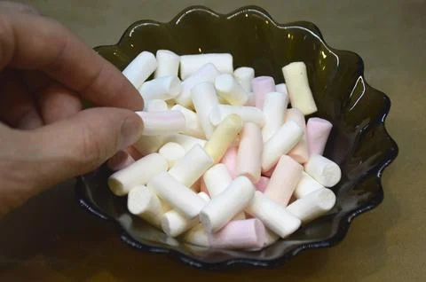Multi-colored sticks of marshmallow marshmallows in a glass bowl Stock Photos