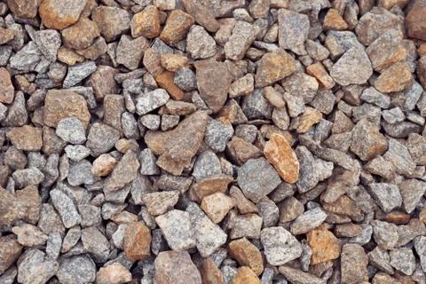 Multi-colored stones on the ground. Different shapes and sizes Foto stock