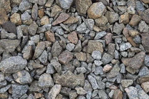 Multi-colored stones on the ground. Different shapes and sizes Foto stock