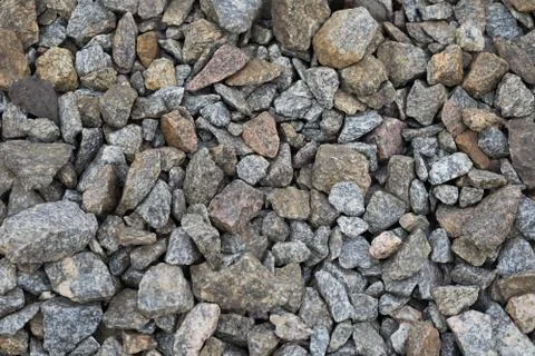 Multi-colored stones on the ground. Different shapes and sizes Foto stock