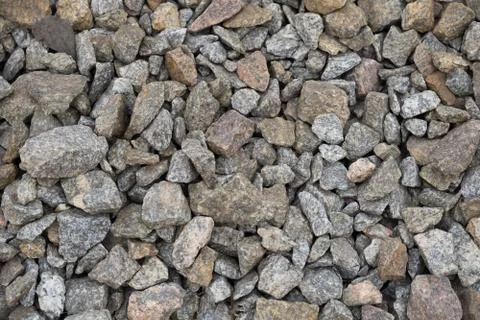 Multi-colored stones on the ground. Different shapes and sizes Foto stock