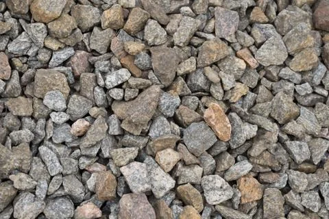 Multi-colored stones on the ground. Different shapes and sizes Stock Photos