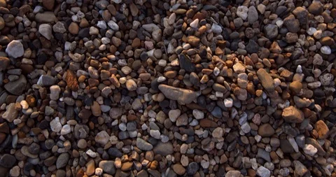Multi-colored stones on the seashore. The movement in the frame on the texture Stock Footage 117281171