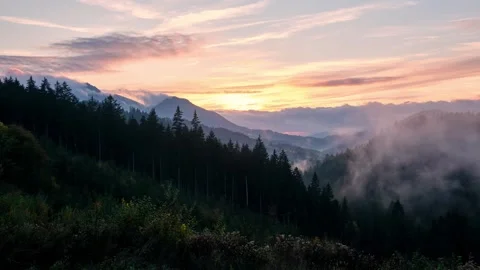 Multi-colored sunset in a cloudy sky over a mountain valley with a autumn forest Stock-Footage 297207840