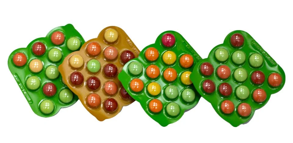 Multi-colored tablets in packaging isolated on a white background. Stock Photos