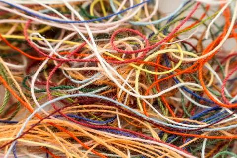 Multi-colored tangled colorful needlecraft silk thread rope. Macro shot. Abst Stock Photos