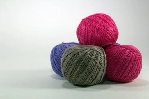 Multi-colored tangles of natural cotton on a white background close-up Stock Photos