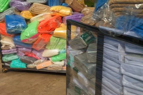 Multi-colored terry towels packed in plastic bags in stock 库存照片