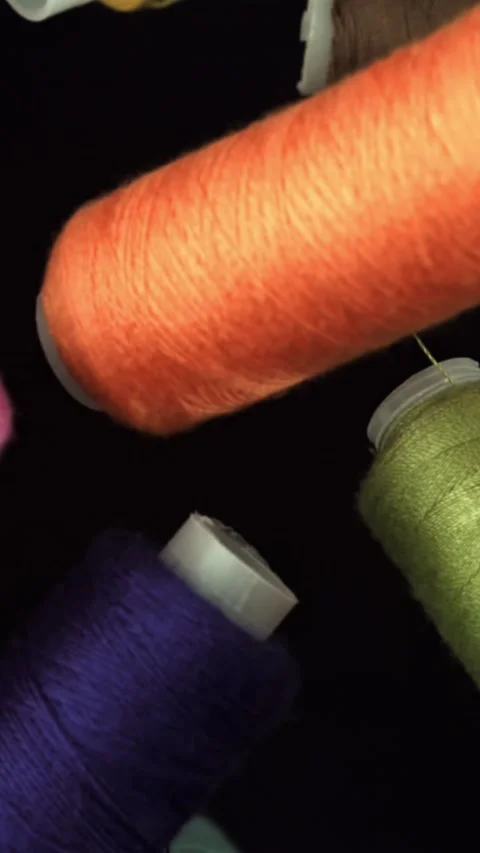 Multi-colored threads fly on a black background. Filmed on a high-speed camera Stock Footage 335376641