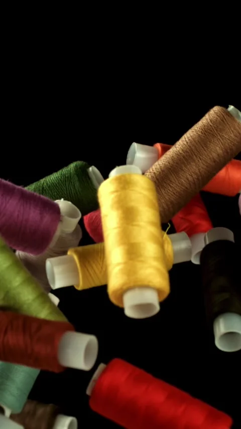 Multi-colored threads fly on a black background. Filmed on a high-speed camera Stock Footage 335379627