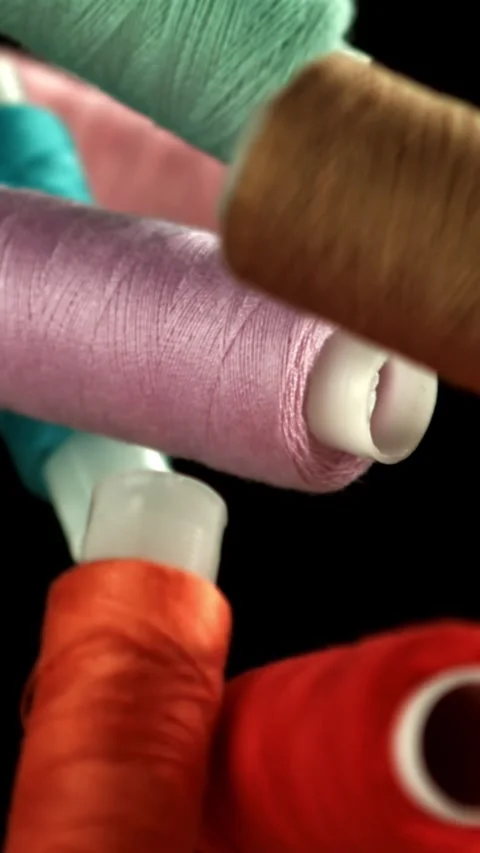 Multi-colored threads fly on a black background. Filmed on a high-speed camera Stock Footage 335381019