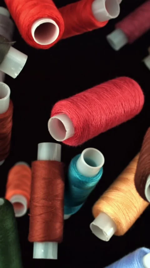 Multi-colored threads fly on a black background. Filmed on a high-speed camera Stock Footage 335381793