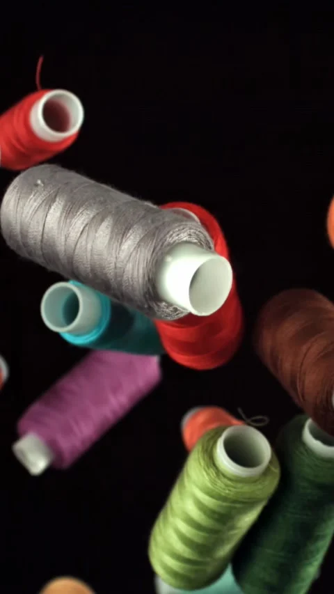 Multi-colored threads fly on a black background. Filmed on a high-speed camera Stock Footage 335384719