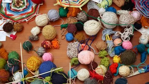Multi-colored threads for handwork lie on the table. Stock Photos