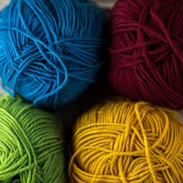 Multi-colored threads for knitting and knitting needles. Selection of colorful Foto stock