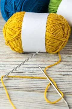 Multi-colored threads for knitting and knitting needles. Selection of colorful Stock Photos