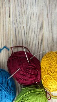 Multi-colored threads for knitting and knitting needles. Selection of colorful Stock Photos